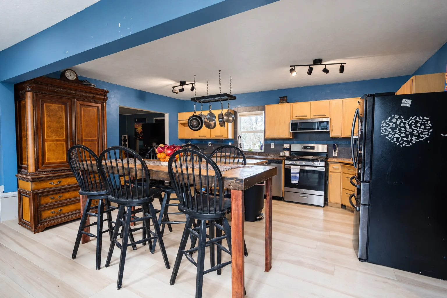 Completed kitchen remodel with wood cabinetry and a dining island